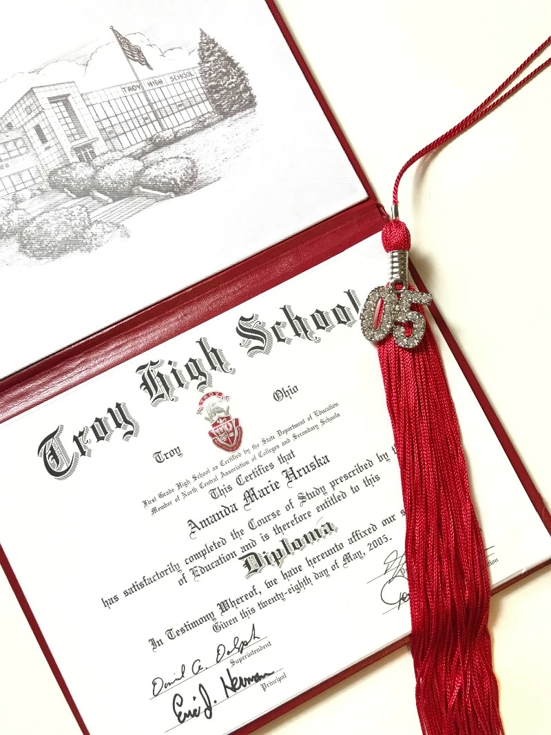 High school graduation diploma and status tassel