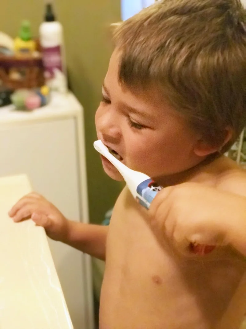 child brushing teeth